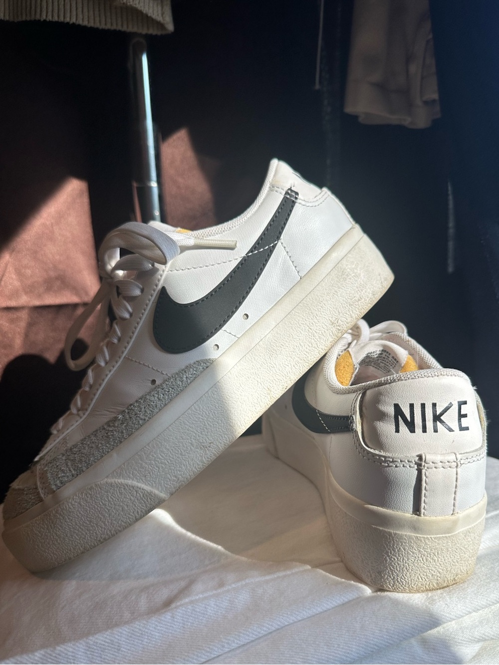Nike White Low-Top Platform Sneakers with Black Swoosh and Yellow Tongue Detail